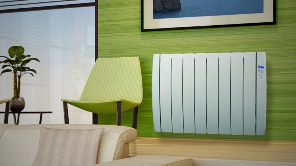 A sleek white electric radiators blending with a green wall